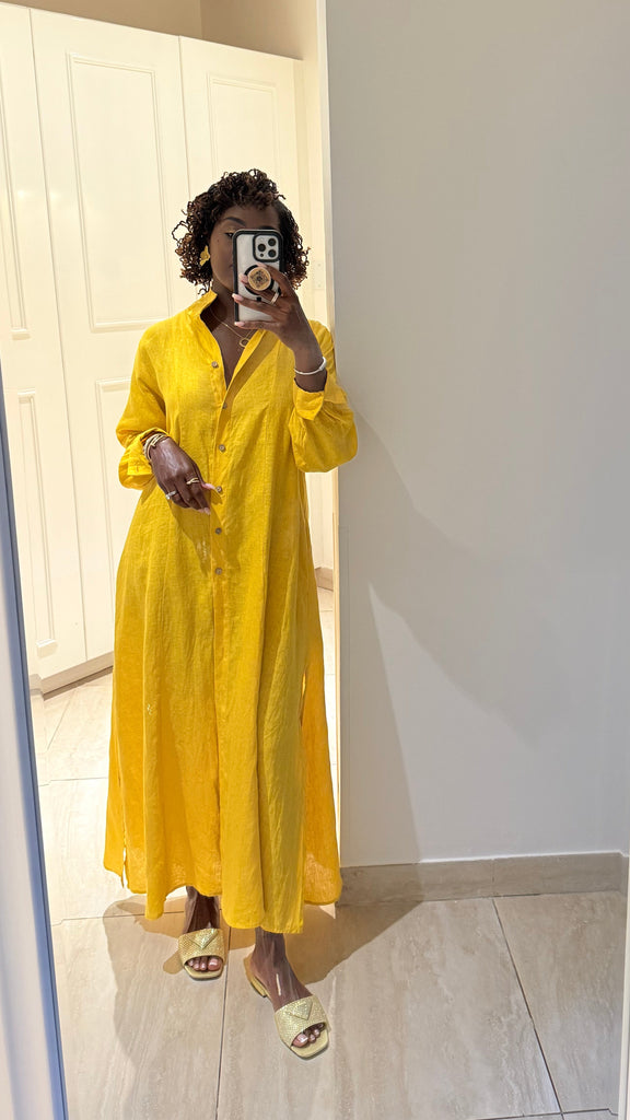 100% Linen maxi length dress in bold yellow. Button front with long sleeves and stand collar. Flowy fit for hot days.