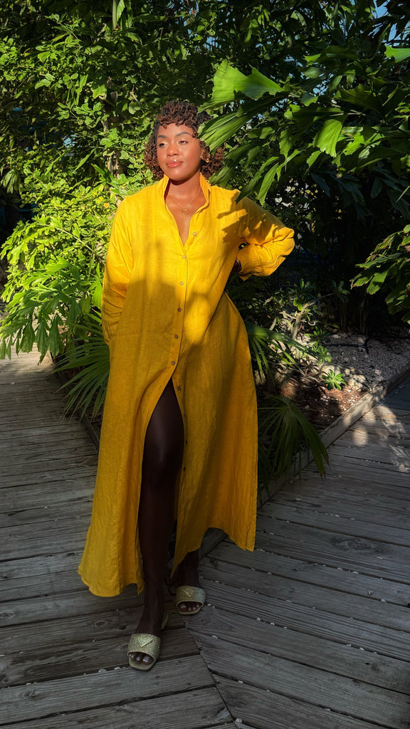 % Linen maxi length dress in bold yellow. Button front with long sleeves and stand collar. Flowy fit for hot days.