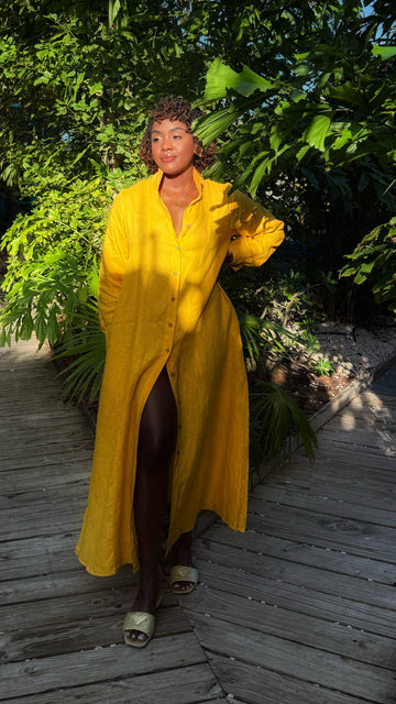 % Linen maxi length dress in bold yellow. Button front with long sleeves and stand collar. Flowy fit for hot days.